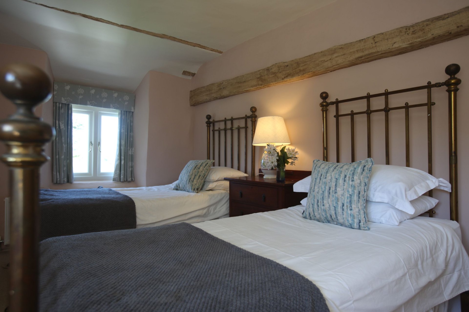 Twin bedroom with antique brass beds